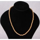 A gold bead necklace stamped 9ct (approximate weight 15.