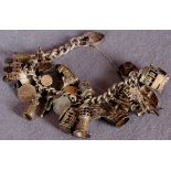 A silver charm bracelet with padlock snap and twenty seven charms dependant (total approximate