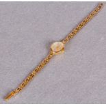 An Accurist lady's gold cased wrist watch, conforming flexible gate link bracelet,