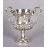 A Victorian plated, two handled football trophy, of waisted and semi-fluted form,