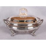 An oval soup tureen and cover, with cast borders, handles and lion paw supports, stamped "Harrods,