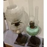 Two metal and glass oil lamps
