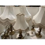 Four brass table lamps with shades,