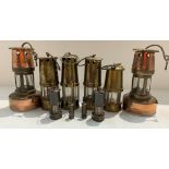 A collection of ten miniature miners lamps,
