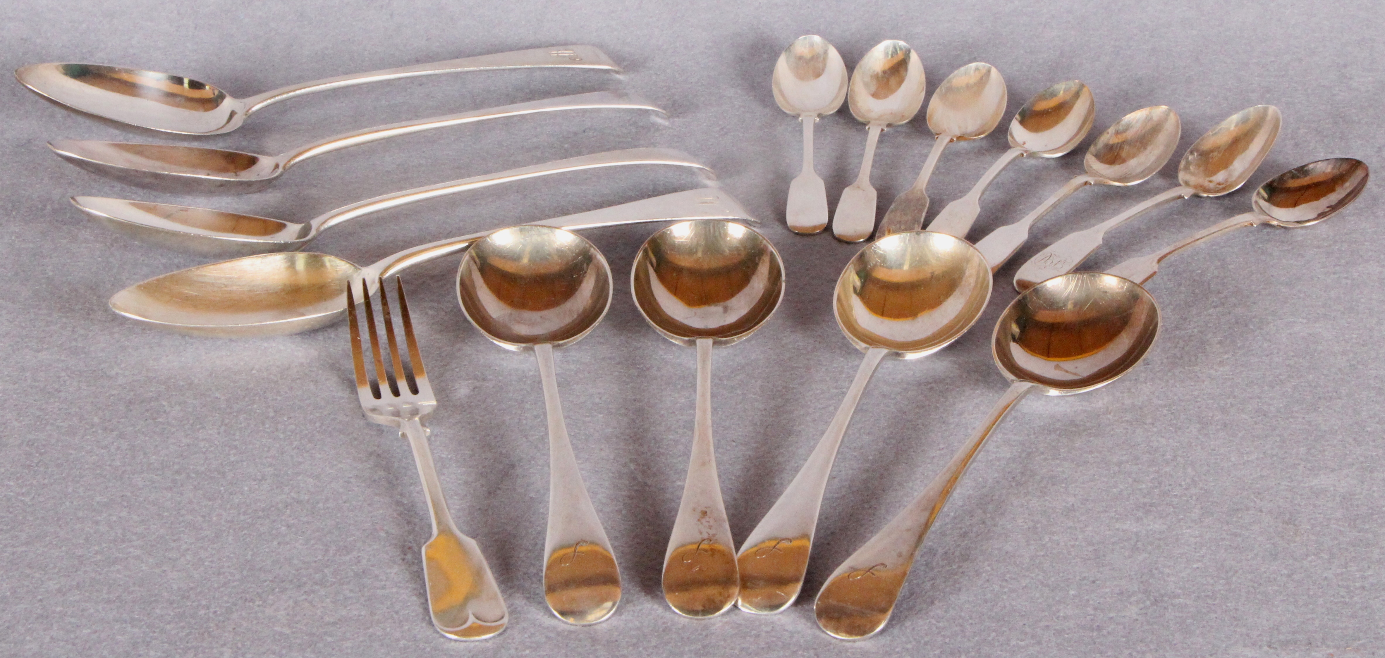 Assorted cutlery including four Georgian Old English pattern table spoons,