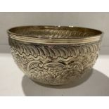 A white metal dish with embossed all over decoration, 165cm diameter, approx weight 12.