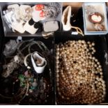 A tray of costume jewellery including necklaces, brooches, paste pearls,