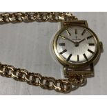 A Candino 14K gold lady's wristwatch with gold loop link bracelet Further Information