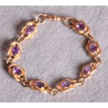 A modern gold bracelet, set with eight oval amethysts, stamped 375 (approximate weight 15.