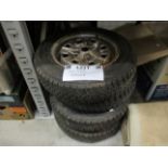A set of four wheels and tyres for an MGA