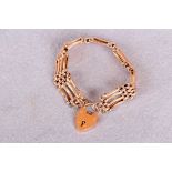 A gold gate link bracelet with padlock snap, stamped 9ct (approximate weight 23.