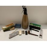 Soda siphon and cartridges, two boxed meerschaum pipes, another pipe, three criterion cigars,