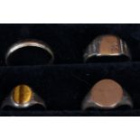 A gold wedding band stamped 375 and three various signet ring two stamped 375,