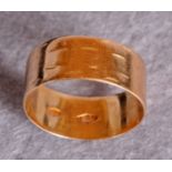 A gold broad wedding band, stamped 750 (approximate weight 3.