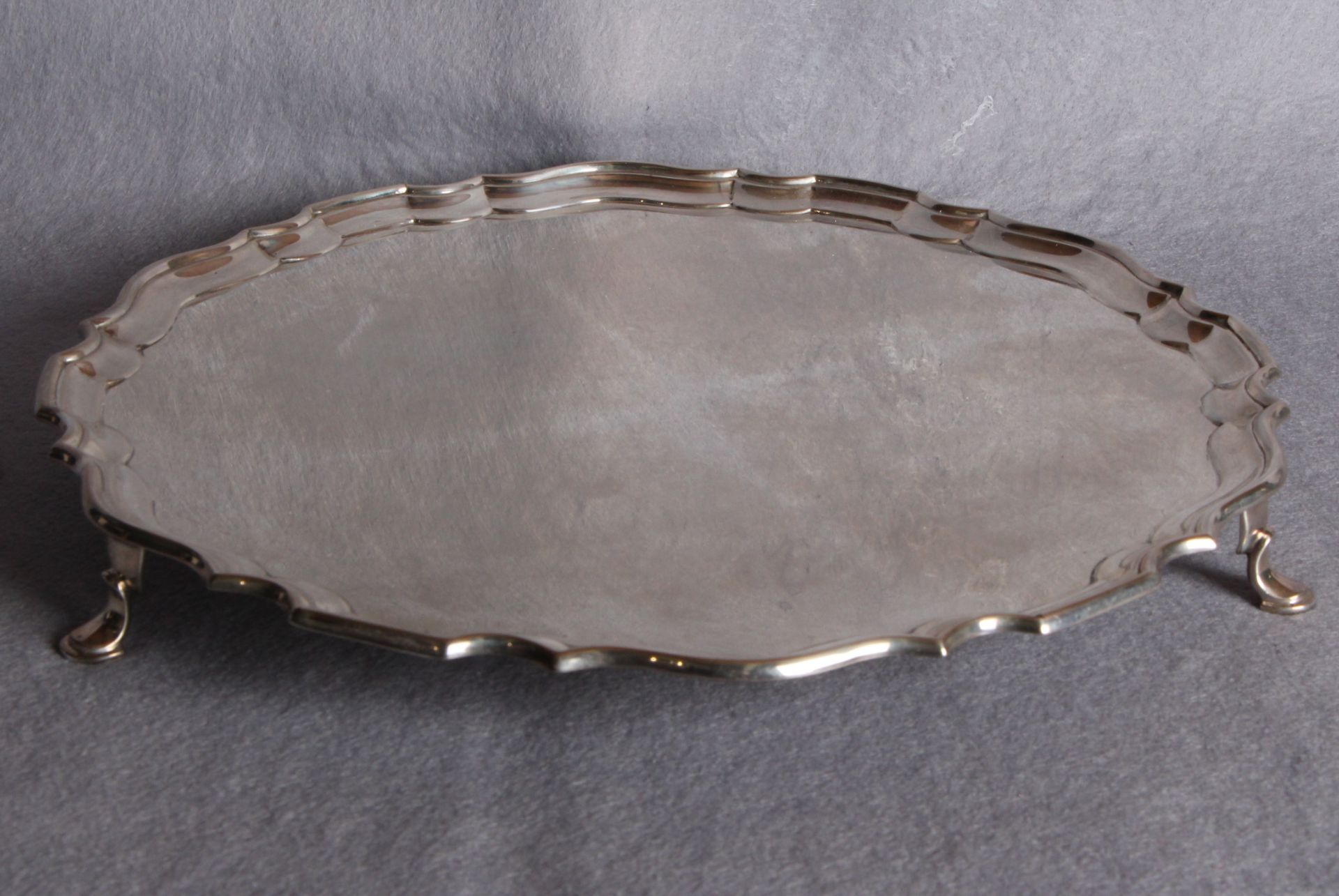 A shaped circular salver,moulded border, three hoof supports, London 1919 (approximate weight 31.