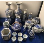 A collection of Japanese blue and white porcelain, including pairs of vases, teapots, fern pot,