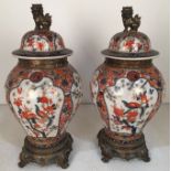 A pair of modern Japanese Imari style china baluster vases and cover,