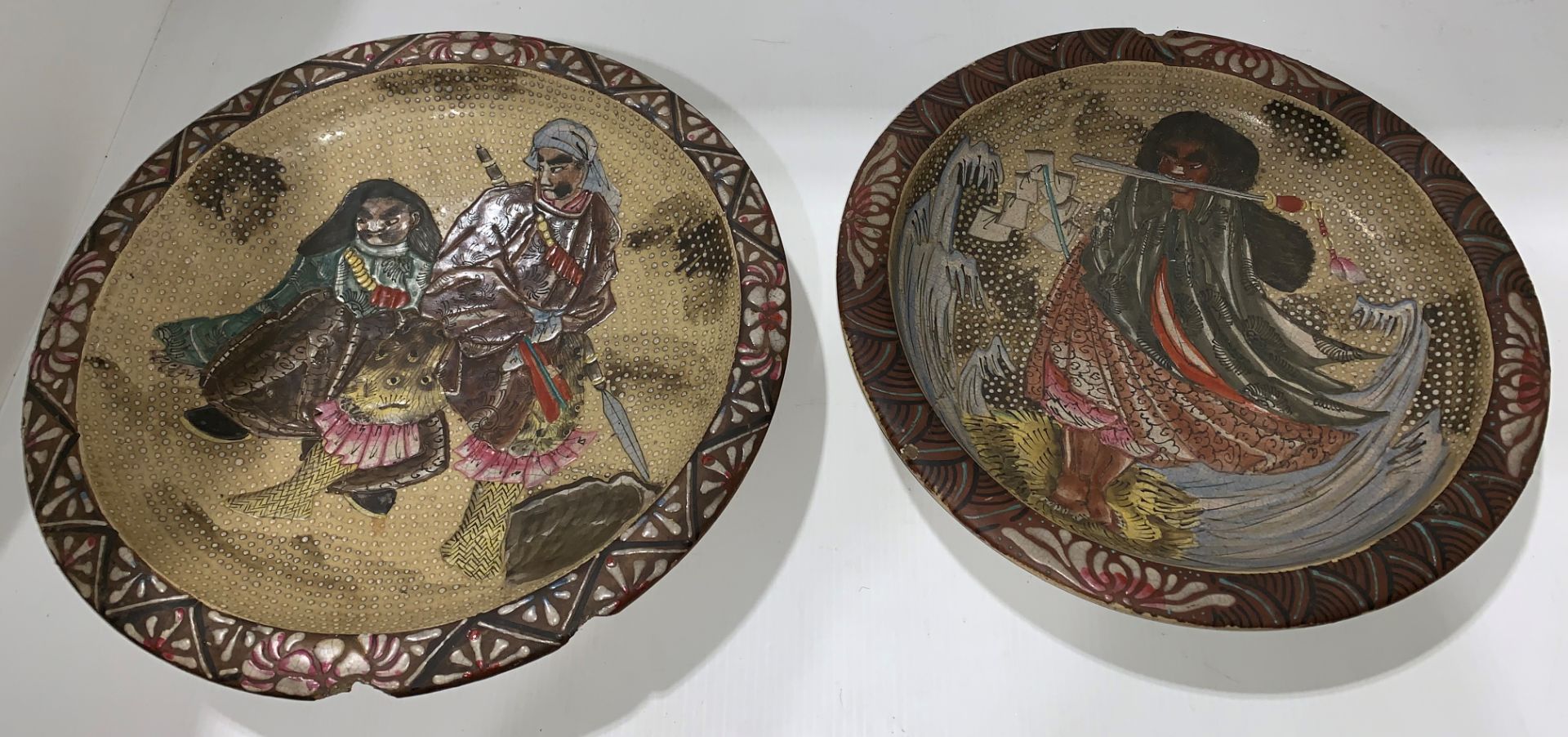 A pair of Japanese satsuma style circular pottery wall plates,