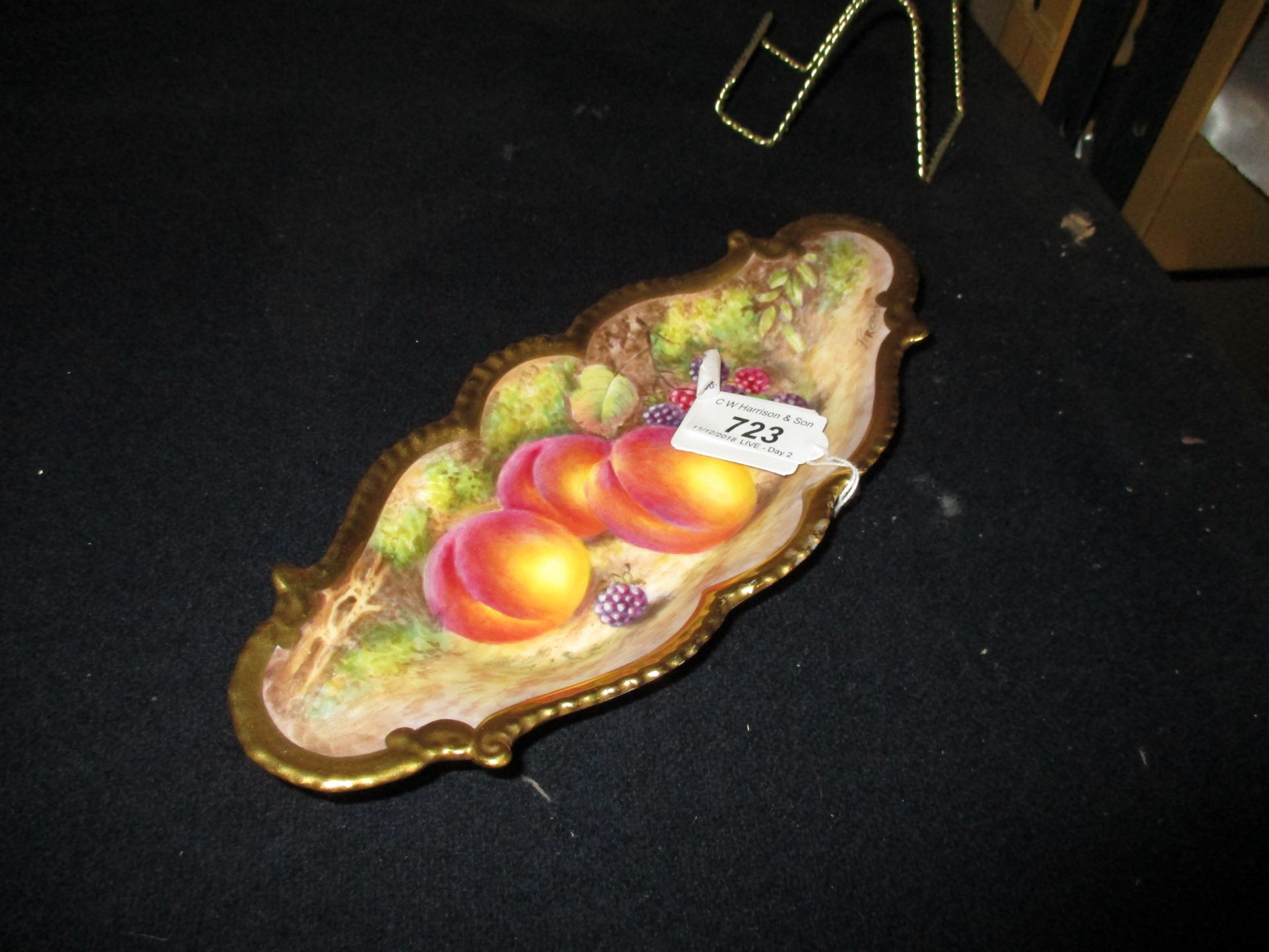 A Royal Worcester oval shaped edged dish painted with fruit, signed J.