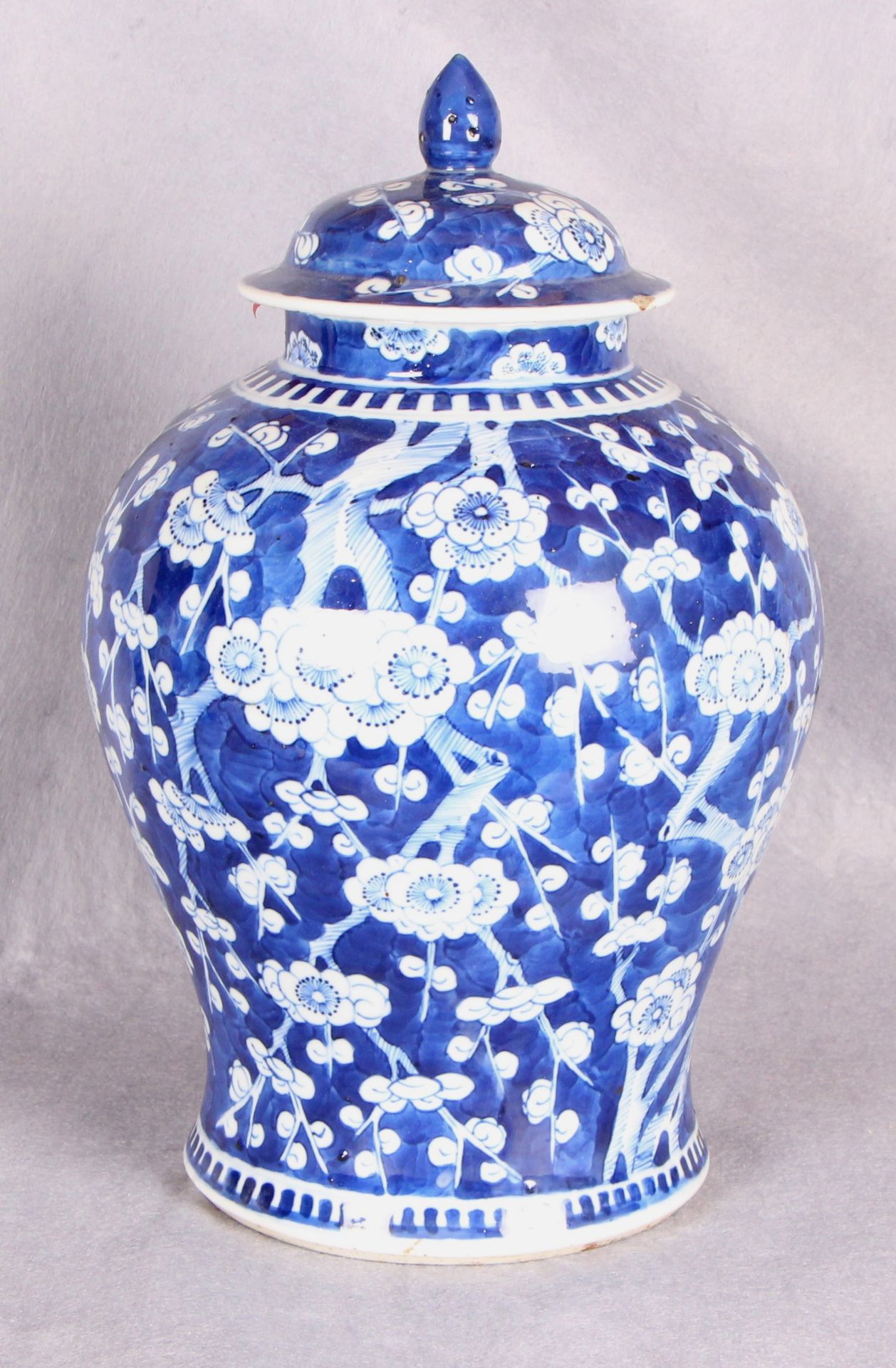 A Chinese porcelain baluster vase and cover, blue and white painted with prunus blossom,