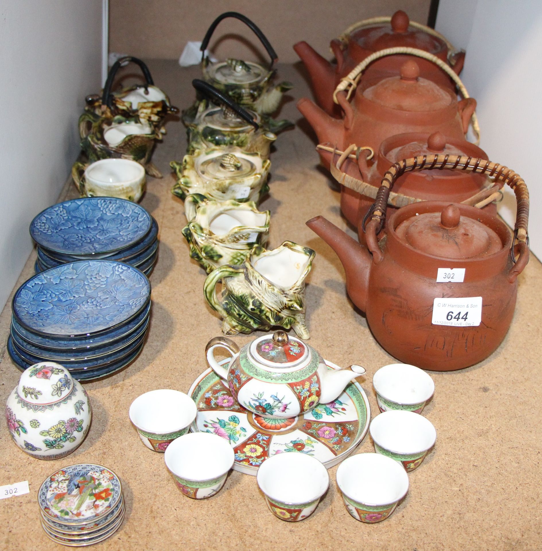 Four Chinese redware pottery teapots, each with cane handle,