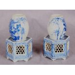 A pair of Japanese blue and white porcelain vases, each on a reticulated hexagonal section base,