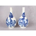 A pair of Chinese blue and white porcelain bottle vases, painted with pairs of lion dogs,