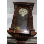 Pendulum wall clock in polished carved wood case 24"