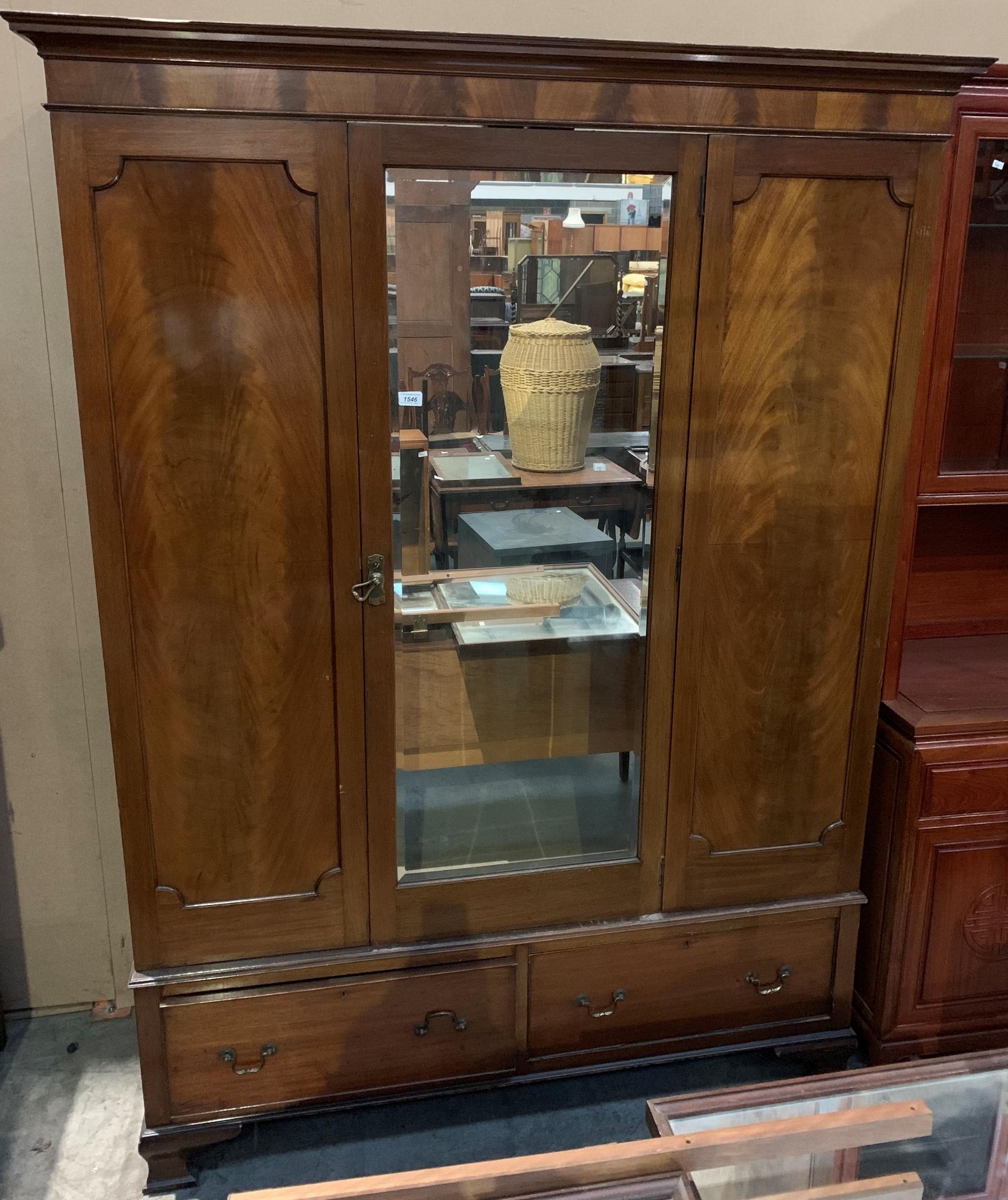 A walnut single mirror door wardrobe with two underdrawers,