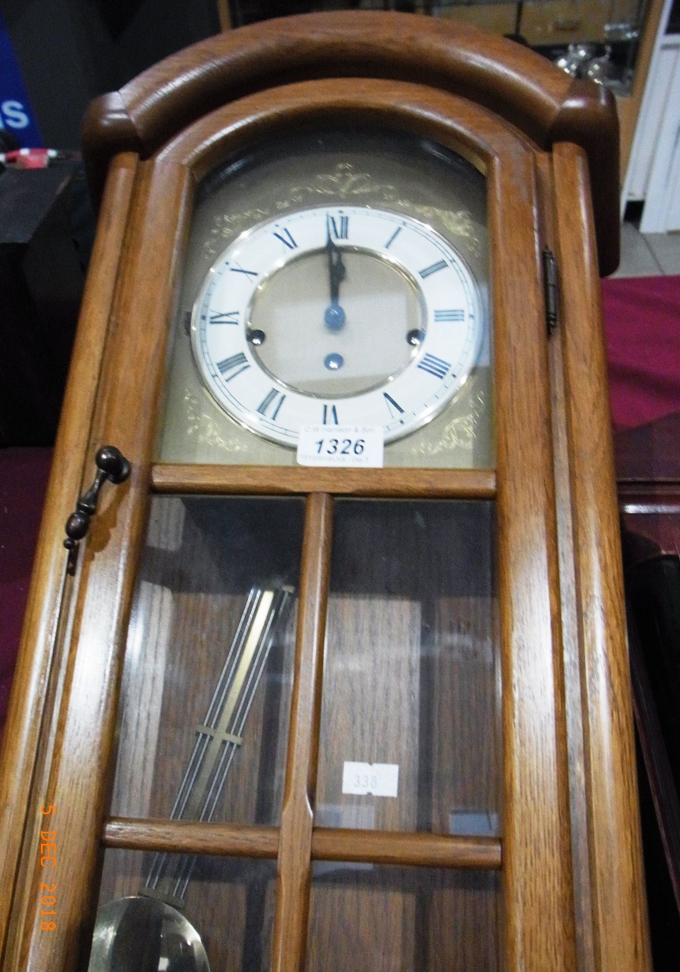 Medium oak cased pendulum wall clock and key 26"