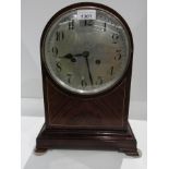 Domed lacquered wooden mantel clock on bracket feet, with key,