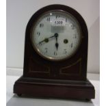 Domed top ebonised mantel clock,