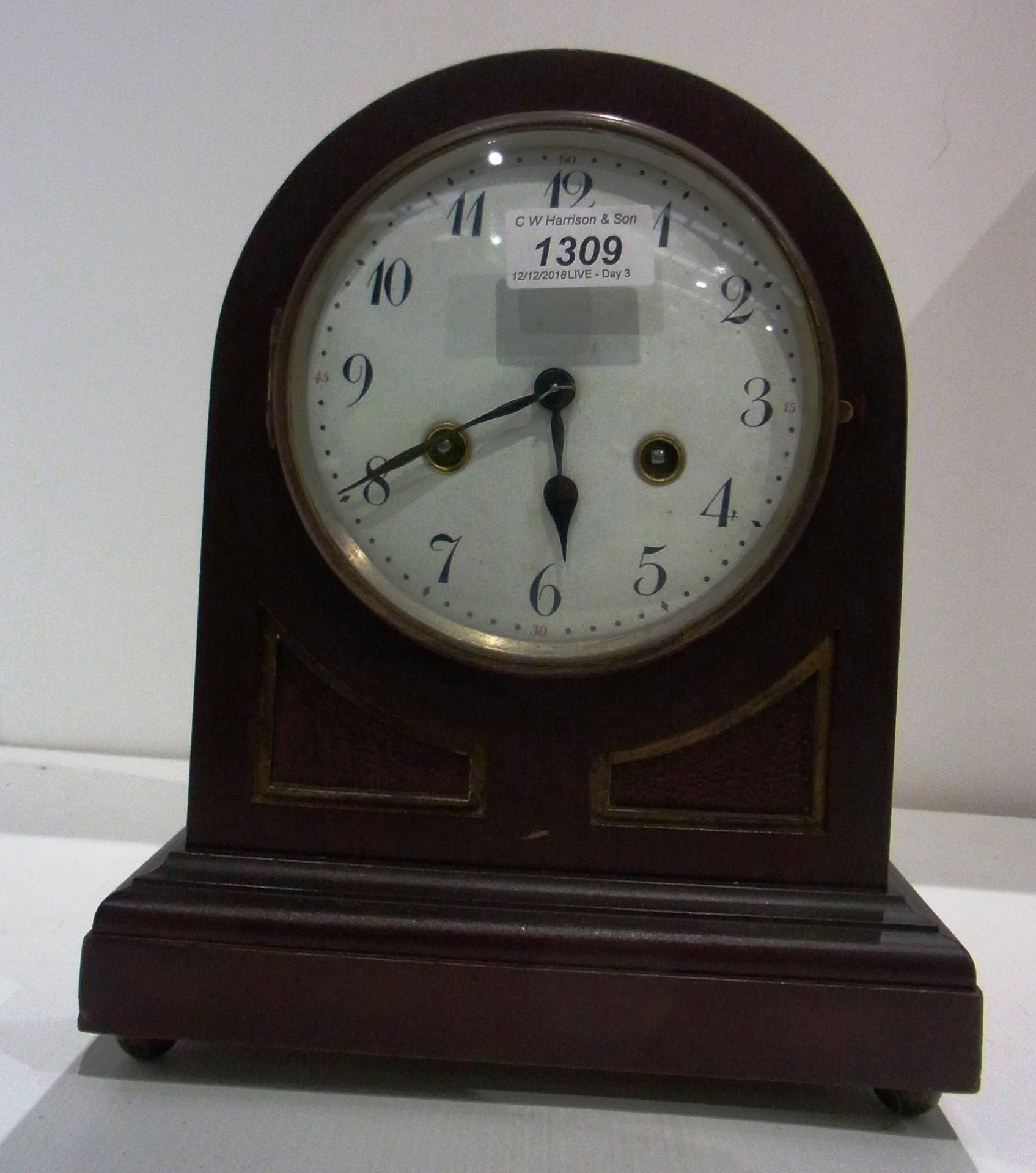 Domed top ebonised mantel clock,
