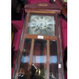 Mahogany cased wall clock with pendulum and key 31"