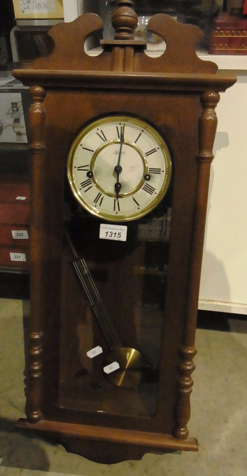 Wall mounted mahogany framed pendulum wall clock by Hermle 29"