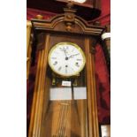 Mahogany framed glazed wall clock by Kieningen with arched pediment and embellishments with key,