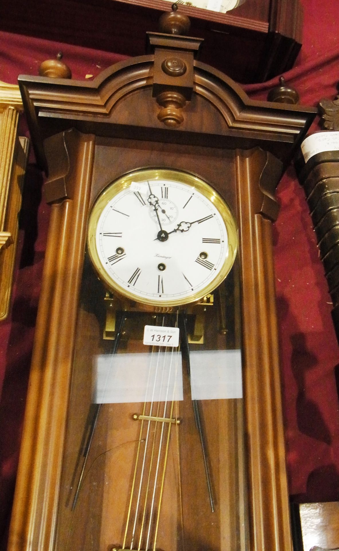 Mahogany framed glazed wall clock by Kieningen with arched pediment and embellishments with key,