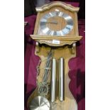 Light oak wall clock by Hermle with pendulum and two weights