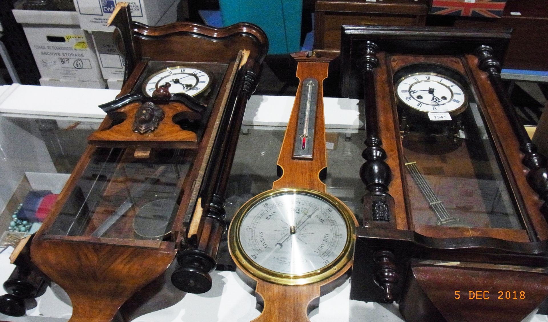 Contents to two Antler suitcases - wall mounted pendulum clock in polished wood case and key with