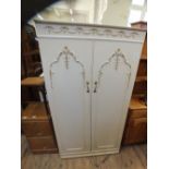 A French style cream and gilt painted two door wardrobe,