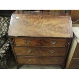 A Georgian mahogany and cross banded bureau with three drawers on bracket feet