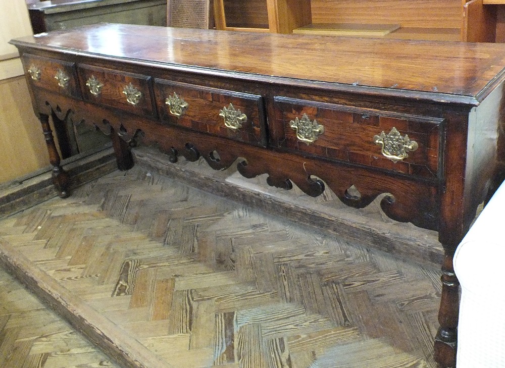 A Regency style oak sideboard with four drawers, brass handles,