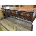 A Regency style oak sideboard with four drawers, brass handles,