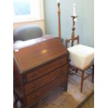 An inlaid and cross banded three drawer bureau with fitted interior and shell marquetry design,