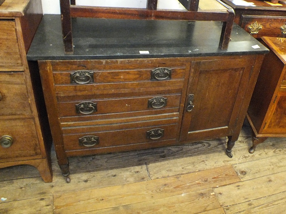 An oak and black marble top washstand