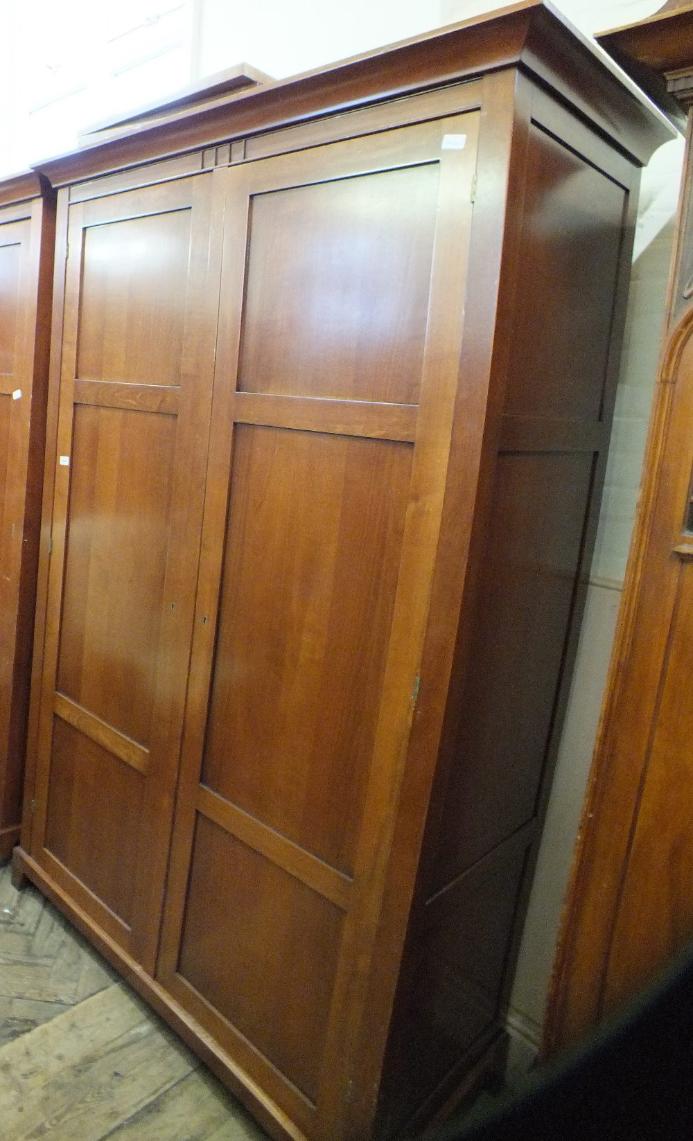 A large modern stained two door wardrobe