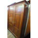 A large modern stained two door wardrobe