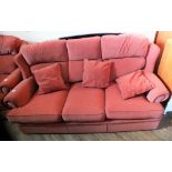 A modern terracotta upholstered three seater sofa