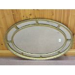 An oval gilt multiple panel wall mirror