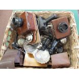 A basket containing vintage telephones, shop bell,